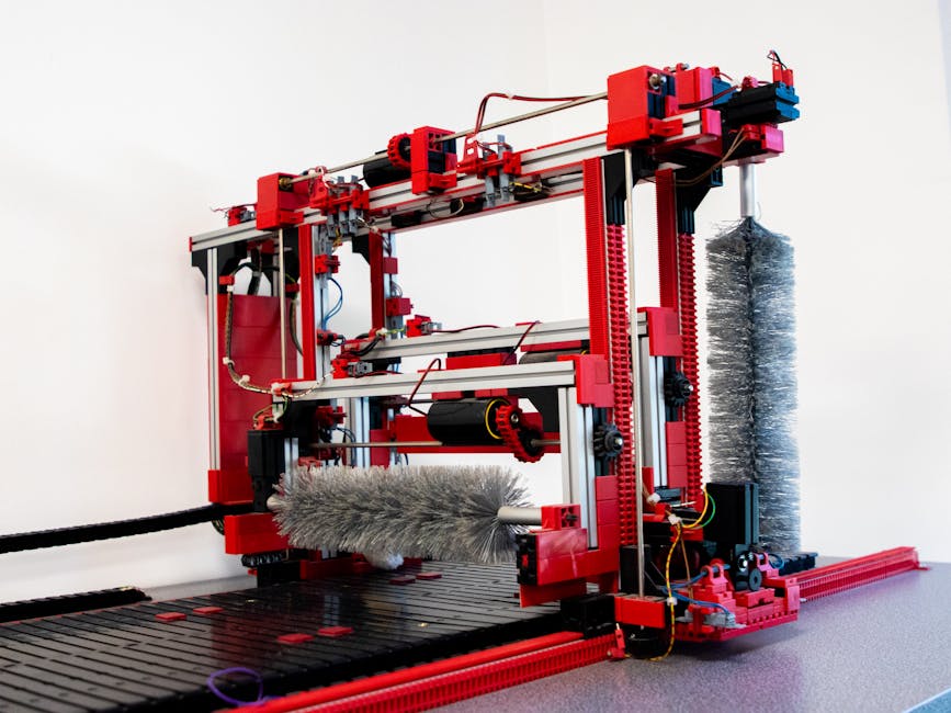 Close-up of a red industrial machine indoors, focusing on intricate machinery and components.